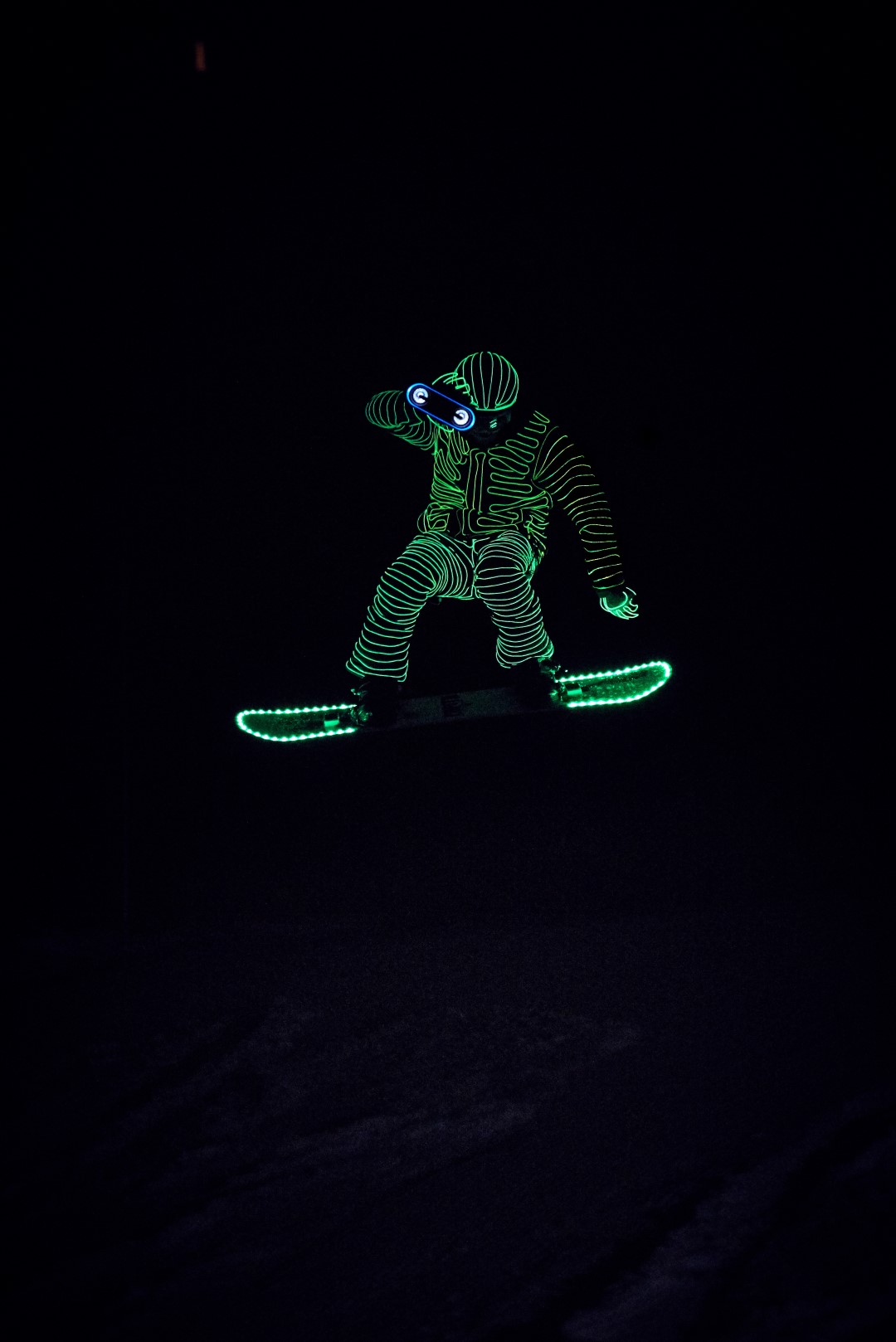 Snowboarders in LED suits