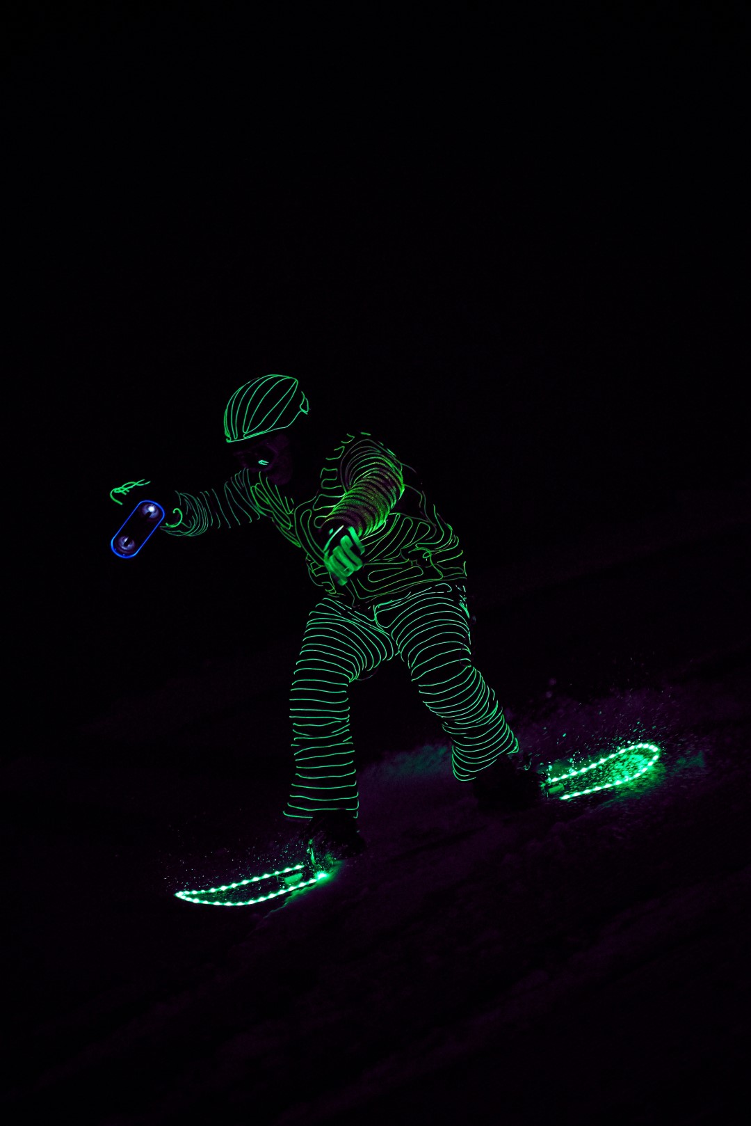 Snowboarders in LED suits